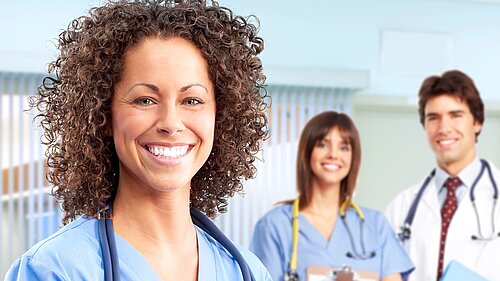 Three doctors smiling.